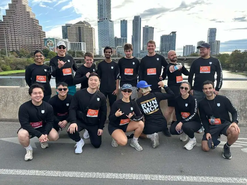 A cohort of Challengers after a run, downtown Austin behind them
